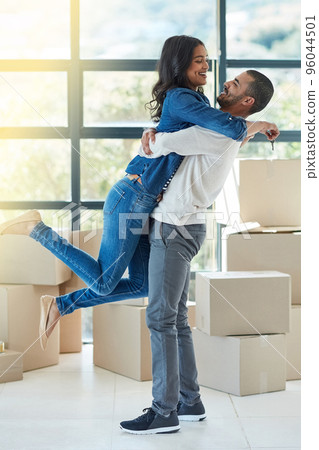 Theyve got a lot to celebrate. Shot of a happy young couple moving into their new home together. 96044501