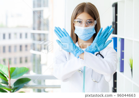 Young european doctor woman crossing arms doing negative sign Young european doctor woman crossing arms doing negative sign 96044663