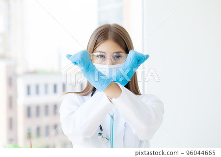 Young european doctor woman crossing arms doing negative sign Young european doctor woman crossing arms doing negative sign 96044665