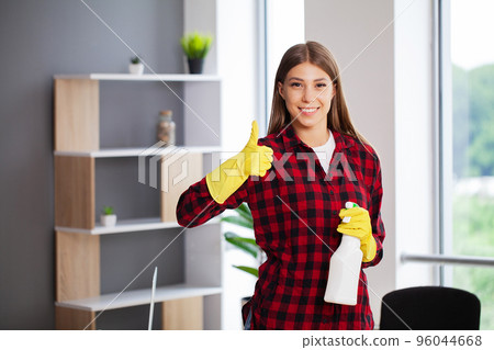 Portrait of happy female worker cleaning modern office Portrait of happy female worker cleaning modern office 96044668