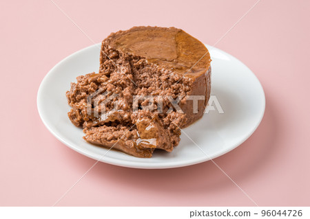 Soft pate for cat on a white plate over pastel pink background. Soft pate for cat on a white plate over pastel pink background. 96044726