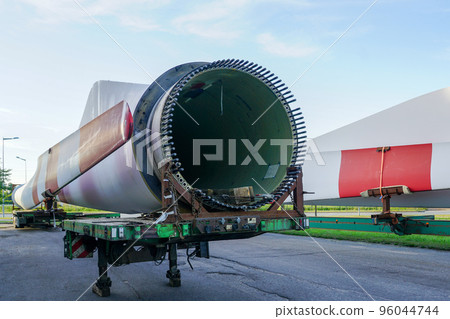 Low-loader semi-trailer with oversized wind generator parts in the parking lot 96044744