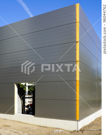 Gray sandwich panels facade of a new metal construction thermally insulated industrial building Gray sandwich panels facade of a new metal construction thermally insulated industrial building 96044762