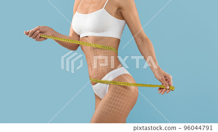 Body Scupting Concept. Slim Woman In Underwear Measuring Waist With Tape Body Scupting Concept. Slim Woman In Underwear Measuring Waist With Tape 96044791