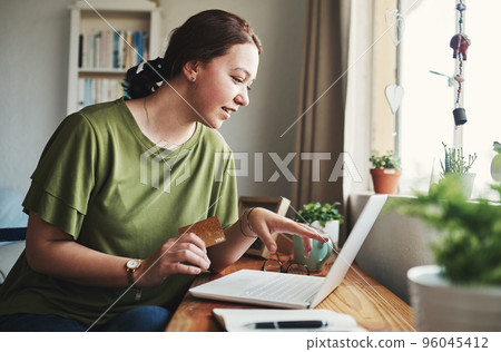This is exactly what I need. Cropped shot of an attractive young businesswoman sitting alone in her home office and using her laptop for online shopping. This is exactly what I need. Cropped shot of an attractive young businesswoman sitting alone in her home office and using her laptop for online shopping. 96045412