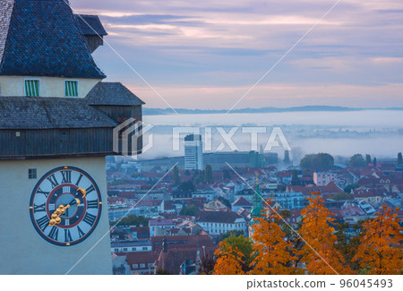 Cityscape of Graz and the famous clock tower (Grazer Uhrturm) on Shlossberg hill, Graz, Styria region, Austria, in autumn, at sunrise Cityscape of Graz and the famous clock tower (Grazer Uhrturm) on Shlossberg hill, Graz, Styria region, Austria, in autumn, at sunrise 96045493