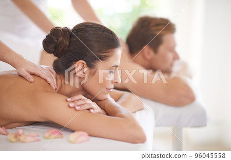 Enjoying a day of pampering. A husband and wife lying together on massage tables. 96045558