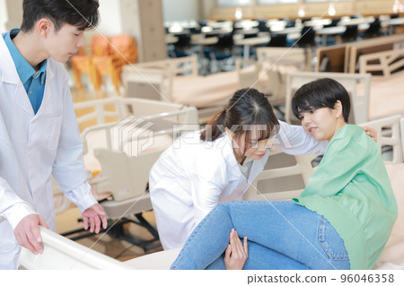 Physiotherapist helping to get up in bed_1 96046358