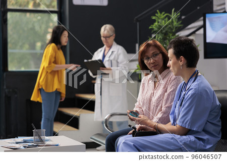 Physician nurse measuring insulin level and glucose in blood sample using glucometer, consulting asian patient with diabetes. Assistant doing medical test with diabetic woman, checkup visit. Physician nurse measuring insulin level and glucose in blood sample using glucometer, consulting asian patient with diabetes. Assistant doing medical test with diabetic woman, checkup visit. 96046507