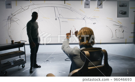 Designers discussing electric car design 96046693