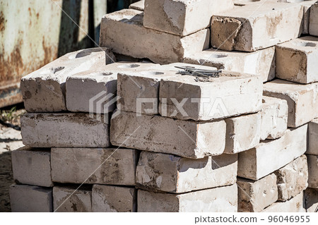 Building materials on site. Construction nails on stack of white bricks. Building materials on site. Construction nails on stack of white bricks. 96046955