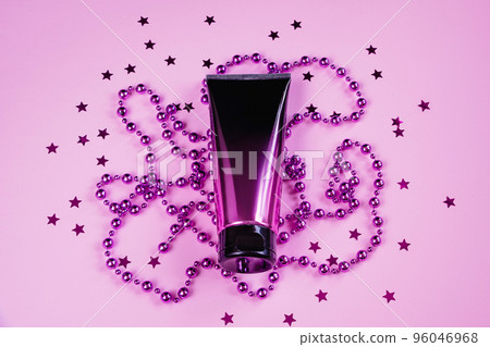 Luxurious black and pink squeeze cosmetic bottles and purple decorations on pastel background. Luxurious black and pink squeeze cosmetic bottles and purple decorations on pastel background. 96046968