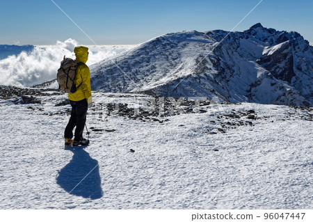 Yatsugatake mountain range in severe winter, climbers on the summit of Mt. Iodake and the ridgeline of Mt. Yokodake 96047447