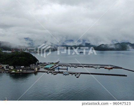 Aerial view of the harbor in Saiki City, Oita Prefecture covered in clouds after the rain Aerial view of the harbor in Saiki City, Oita Prefecture covered in clouds after the rain 96047523