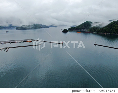 Aerial view of the harbor in Saiki City, Oita Prefecture covered in clouds after the rain Aerial view of the harbor in Saiki City, Oita Prefecture covered in clouds after the rain 96047524