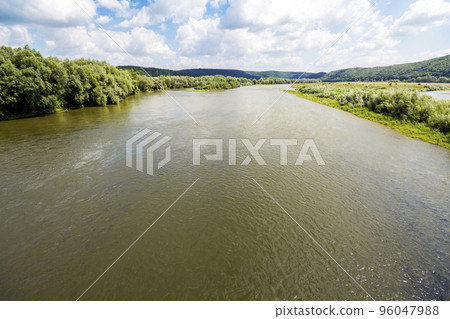 Water in wide river in summer with green trees on the banks 96047988