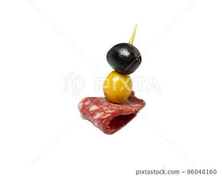 Kanape.  Slicing salami and olives on toothpicks. 96048160