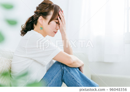 Japanese woman suffering from headache, hormonal imbalance and stress in the room 96048356