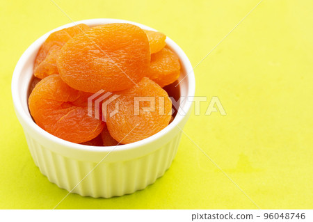 Dried apricots on green background. 96048746