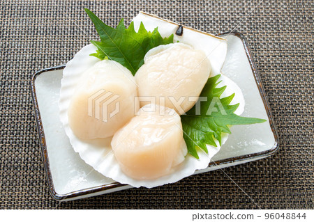 扇貝生魚片放在扇貝殼上。 96048844