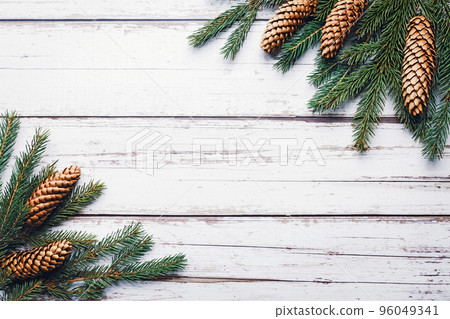 Spruce twigs and cones on white wooden background, christmas flat lay, copy space Spruce twigs and cones on white wooden background, christmas flat lay, copy space 96049341