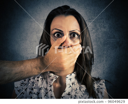 Woman terrified by the violence Woman terrified by the violence 96049629