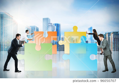 Concept of teamwork and partnership with businesspeople and puzzle. 96050707