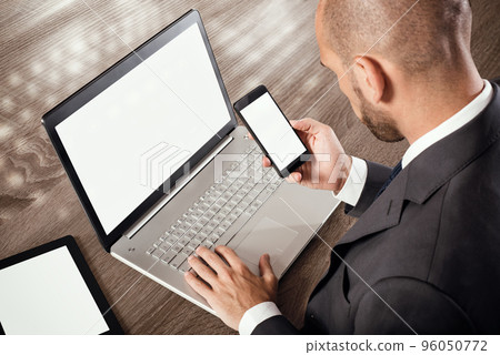 Busy businessman works with technology 96050772