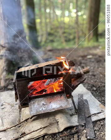Camping bonfire surrounded by trees in the mountains 96051888