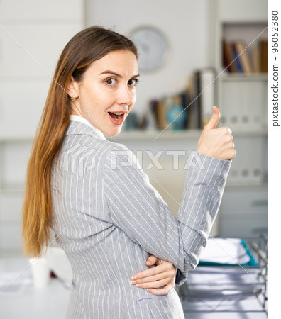 Woman office worker making thumb up gesture 96052380
