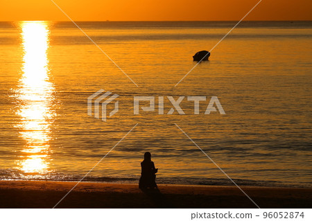 A woman looking at the sea dyed in the sunset on the Zushi coast in autumn A woman looking at the sea dyed in the sunset on the Zushi coast in autumn 96052874