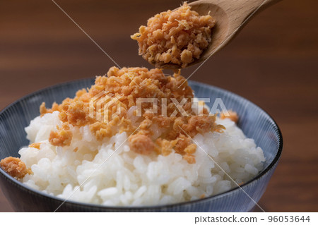 Eat with salmon flakes over white rice Eat with salmon flakes over white rice 96053644