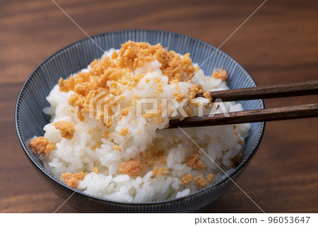 Eat with salmon flakes over white rice Eat with salmon flakes over white rice 96053647