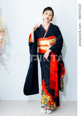 A woman in a black long-sleeved kimono A woman in a black long-sleeved kimono 96055020
