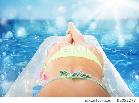 Summer tanning on airbed Summer tanning on airbed 96055278