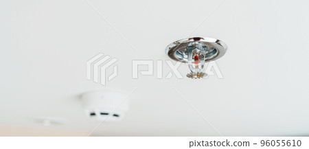 Fire Sprinkler and Smoke sensor detector mounted on roof in home or apartment. Safety and conflagration security concept 96055610