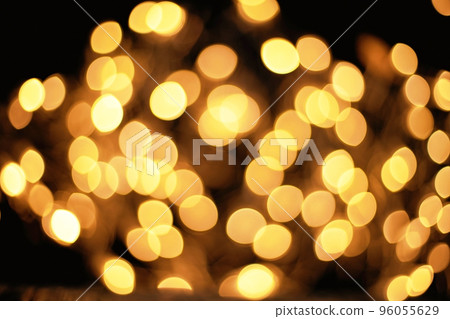 blurred golden lights on a black background . 96055629