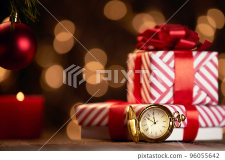 clocks and Christmas boxes on a festive background. clocks and Christmas boxes on a festive background. 96055642