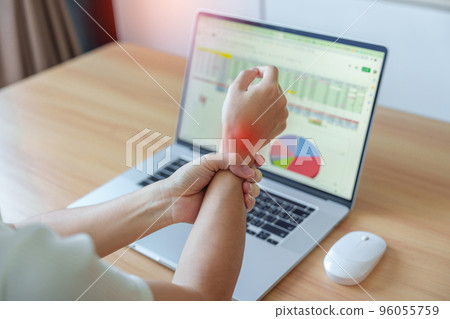 Woman having wrist pain when using mouse during working long time on workplace. De Quervain s tenosynovitis, ergonomic, Carpal Tunnel Syndrome or Office syndrome concept 96055759