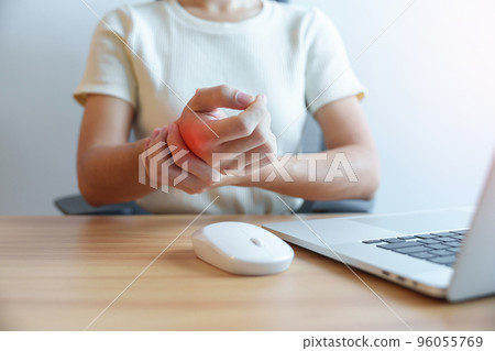 Woman having wrist pain when using mouse during working long time on workplace. De Quervain s tenosynovitis, ergonomic, Carpal Tunnel Syndrome or Office syndrome concept 96055769