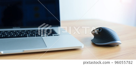 Ergonomic vertical mouse with laptop computer on adjustable desk at workplace, prevention wrist pain. De Quervain s tenosynovitis, Intersection Symptom, Carpal Tunnel or Office syndrome concept Ergonomic vertical mouse with laptop computer on adjustable desk at workplace, prevention wrist pain. De Quervain s tenosynovitis, Intersection Symptom, Carpal Tunnel or Office syndrome concept 96055782