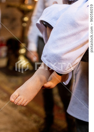 feet of a child at a christening in a church on a holiday 96056059