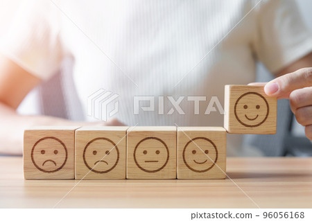 Hand choosing smile face from Emotion block. customer review, good experience, positive feedback, satisfaction, survey, rating service, assessment, mood, world mental health day concept Hand choosing smile face from Emotion block. customer review, good experience, positive feedback, satisfaction, survey, rating service, assessment, mood, world mental health day concept 96056168