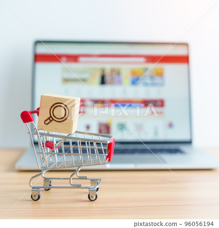 Shopping cart with Magnifying icon block and laptop computer with marketplace website, technology, ecommerce, SEO, Search Engine Optimization, Advertising, keyword and online payment concept 96056194