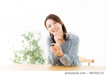 A woman with a cell phone A woman with a cell phone 96056519