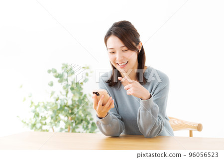 A woman with a cell phone A woman with a cell phone 96056523