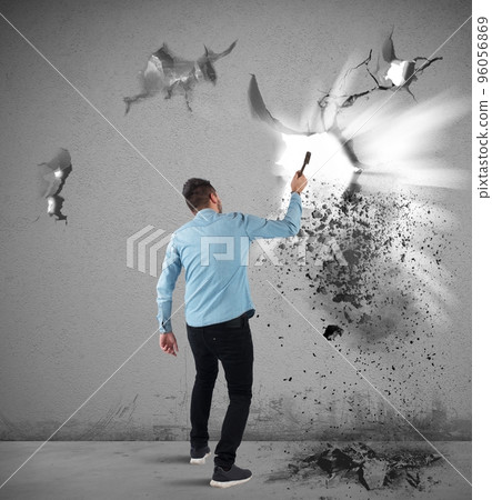 Man breaks a wall Man breaks a wall 96056869
