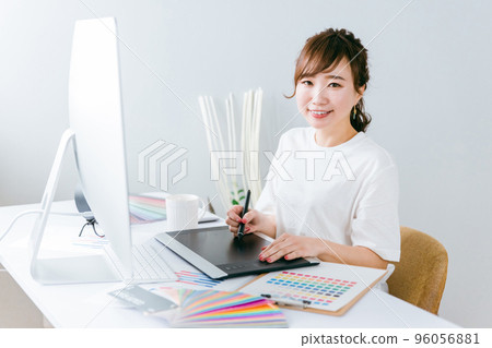 A Japanese woman doing creative work with a pen tablet (designer, illustrator, creator) 96056881