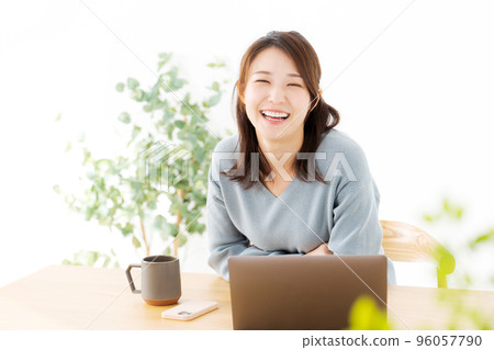 Woman operating a personal computer Woman operating a personal computer 96057790