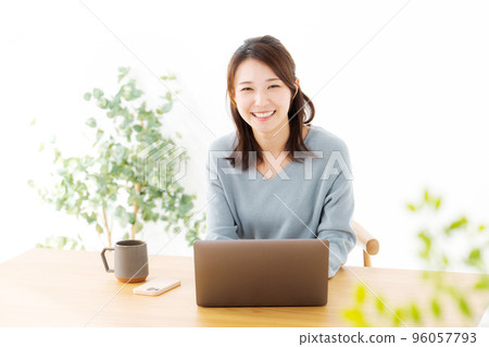 Woman operating a personal computer Woman operating a personal computer 96057793
